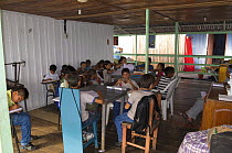 Children using the floating local store for lessons after their school flooded, Rio Negro, Amazonia, Brazil, June 2012