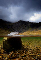 A split level image of Llyn Idwal, Snowdonia, with the Idwal Slabs in the background. Gwynedd, Wales, September 2011.