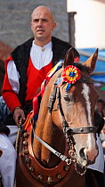 Traditionally dressed rider parading during the Madonna dei Martiri festival, in Fonni, Nuoro district, Sardinia, Italy.