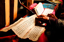 Reading script during Buddhist Ceremony at the Ligaon Buddhist monastery (2.910m). Manaslu Conservation Area, Himalayas, Nepal, October 2009.