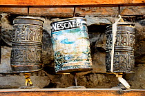 Buddhist prayer wheels with old Nescafe tin replacing traditions wheel, Manang (3.540m). Annapurna Conservation Area, Himalayas, Nepal, October 2009.