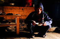 A porter with a hot soup in Samdo lodge (3.690m). Manaslu Conservation Area, Himalayas, Nepal, October 2009.