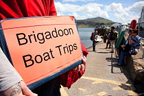 Tourist signs promoting boat trips based around the presence of White tailed sea eagles, Portree, Skye, Inner Hebrides, Scotland, UK, June 2011. 2020VISION Book Plate.