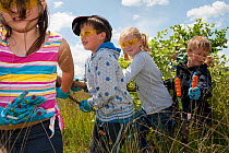 Children from St John and St Francis Church of England School helping with ground clearance at Westhay Nature Reserve, Somerset Levels, England, UK, June 2011. Model released. 2020VISION Book Plate.