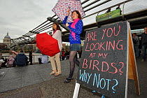 People walking past a sign advertising the RSPB 'Date With Nature Event' for learning about urban Peregrine falcons, Tate Modern, South Bank, London, UK, September 2011, RSPB Greater Thames Futurescap...