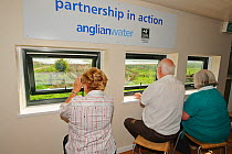 Visitors birdwatching from the Anglian Bird Watching Centre, Rutland Water, Rutland, England, UK, April 2011. 2020VISION Book Plate.