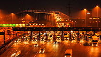 Timelapse of traffic using the Dartford Crossing at night, with the Queen Elizabeth II Bridge in the background, Kent, England, UK, March 2012