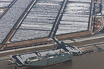 Aerial view of Emden Port, with boat at harbour and new cars for shipping overseas, East Frisia, Lower Saxony, Germany February 2012