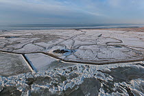 Aerial view of Hallig Island Nordstrandischmoor, in winter with snow and ice on the Wadden Sea, Schleswig-Holstein National Park, North Sea, Germany February 2012