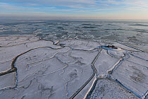 Aerial view of Neuwarft on Hallig Island Nordstrandischmoor, in winter with snow and ice on the Wadden Sea, Schleswig-Holstein National Park, North Sea, Germany February 2012