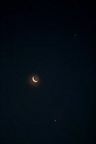 The Moon (waning crescent) with Venus (below) and Jupiter (above) as seen 50 minutes before a 0545 sunrise on the morning of 15 July 2012 from Aurora, Colorado, USA