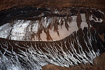 Abstract pattern of ice, sand and volcanic ash on the mountain side of Reykjafjoll in the Fjallabak Nature Reserve, Hrafntinnusker, Iceland, August 2010