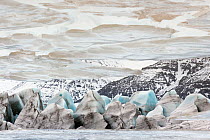 The Svinafellsjokull glacier at the Vatnajökull ice cap in winter by a meltwater lake, Skaftafell National Park, Iceland. March 2011