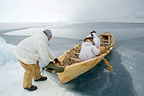 Inupiaq subsistence whalers get into their umiak - or bearded seal skin boat - in order to break thin ice forming in the open lead, allowing for passing bowhead whales during spring whaling season. Ch...
