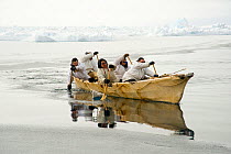 Inupiaq subsistence whalers paddle their umiak, or bearded seal skin boat, to find passing bowhead whales traveling through the open lead, during spring whaling season. Chukchi Sea, offshore from Barr...