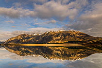 Broken Hill and clouds being reflected in the calm waters of Lake Pearson Flock Hill Station, Canterbury, South Island, New Zealand. June, 2005.