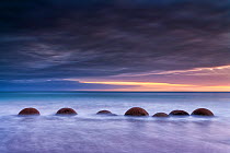 RF- Moeraki Boulder / Kaihinaki on Koekohe Beach at sunrise. 60 Million year old mudstone concretions. Moeraki, Waitaki District, Otago Region, South Island, New Zealand. January, 2012. (This image ma...