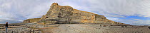 Wide angle panoramic view of limestone rocky beach at Macross, with person standing on beach, Glamorgan, Wales, UK