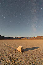 Sliding Stone or Moving Rock of Racetrack Playa, taken at night by moonlight, with the stars of the Milky Way in the background, Death Valley, California, USA