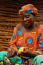 Bassari woman preparing vegetables. Bassari country, east Senegal. This area became a UNESCO World Heritage site in 2012, for cultural landscape and traditions kept by the the Bassari, Fula and Bedik...