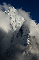 Ama Dablam (6856m) surrounded by clouds, Sagarmatha National Park (World Heritage UNESCO). Khumbu / Everest Region, Nepal, Himalaya, October 2011.
