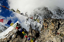 Prayer flags at Pumori Peak (7145 m) seen from Kala Pattar (5545 m), Sagarmatha National Park (World Heritage UNESCO). Khumbu / Everest Region, Nepal, Himalaya, October 2011.