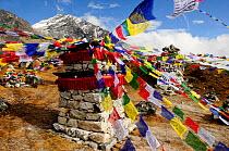 Prayer flags at memorial in Khumbu Valley, Sagarmatha National Park (World Heritage UNESCO). Khumbu / Everest Region, Nepal, Himalaya, October 2011.
