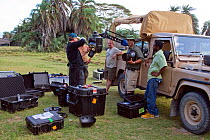 Simon Werry (watched by cameramen Mike Cuthbert and Martyn Colbeck) rigging Cineflex yogicam in back of vehicle. Amboseli, Kenya. December 2007. Taken on location for BBC tv series 'Life'