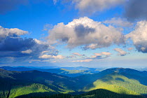 Clouds casting shadow over the Leota mountain range, Arges County, Carpathian Mountains, Romania, July