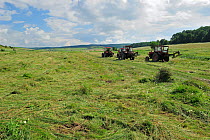 Tractors cutting grass for hay, Cobor, Brasov, Carpathian Mountains, Romania, August, 2011