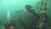Divers exploring the weck of the Jane, Fetlar, Shetland, Scotland, UK, July 2012.