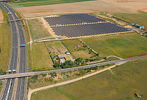 Aerial image of motorway next to solar energy power station, Salamanca Region, Castilla y Leon, Spain May 2011