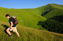 Adrian Hagatis, WWF Romania, hiking in Alpine grasslands in the Tarku mountains Natura 2000 site, Southern Carpathians, Rewilding Europe site, Romania, June 2011