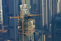 Aerial view of construction of sky scrapers in Dubai, showing crane. Central Strip near 'Burj Khalifa' United Arab Emirates, UAE, January 2010