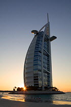 Burj Al Arab Hotel, on Jumeirah Beach at sunset, Dubai, United Arab Emirates (UAE), January 2010
