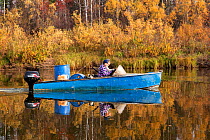 Selkup hunter, Igor Kubolev, and his girlfriend Rita travelling by boat on the River Shirta in the autumn, Krasnoselkup, Yamal, Western Siberia, Russia
