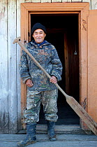 Andrey Kargochev, a Selkup elder, prepares to go hunting by boat, Tolka, Krasnoselkup, Yamal, Western Siberia, Russia
