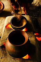 Rice cooking in clay pots over fire, Bangladesh, June 2012.