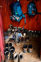 Hiking boots and backpacks at the entrance of Grey mountain hut, trekking in National Park Torres del Paine, Patagonia, Chile