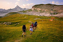 People Hiking at sunrise on the trail to Anie peak (2507 m) in Belagua valley, Pyrenees, Navarra, Spain
