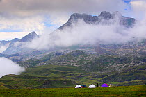 Mountaineers camping in Aguas Tuertas with mist in Hecho valley, Los Valles Occidentales Natural Park, Pyrenees, Aragon, Spain