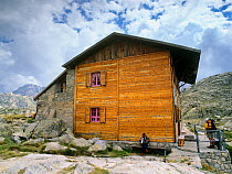 Colomina mountain hut, with man playing the accordian, Aiguestortes i Estany de Sant Maurici National Park, Vall Fosca, Pyrenees Pallars Jussa, Catalonia, Spain