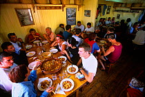 Mountain walkers dining at Colomina mountain hut, Aiguestortes i Estany de Sant Maurici National Park, Vall Fosca, Pyrenees, Catalonia, Spain
