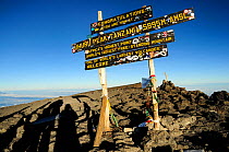 Board indicating Uhuru peak on Mount Kilimanjaro, Africa's highest point at 5895m altitude, Tanzania