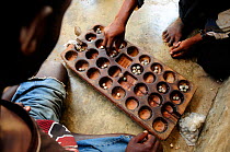Bao is a traditional mancala board game played in most of East Africa, here in Zanzibar Town (Stone Town) Zanzibar, Tanzania