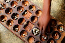 Bao is a traditional mancala board game played in most of East Africa, here in Zanzibar Town (Stone Town) Zanzibar, Tanzania