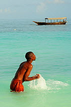 Man bathing in sea, Nungwi Beach, North Coast, Zanzibar, Tanzania