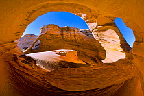 Wind and blowing sand has, over millions of years, carved incredible forms out of the Southwest's sandstone, such as this alcove and double arch. Vermilion Cliffs, Arizona, USA