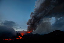 Dark ash plume and stream of red hot  lava from Plosky Tolbachik Volcano eruption, Kamchatka Peninsula, Russia, 15 December 2012