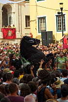 Lady riding a black Menorquin stallion, performing the bot or walking courbette of the Doma Menorquina, during the festival Mare de Deu de Gracia, in Mahon, Menorca, Spain 2012.  People try to touch t...